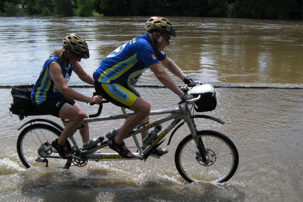 Tandem cycling beside a very swollen River Cher